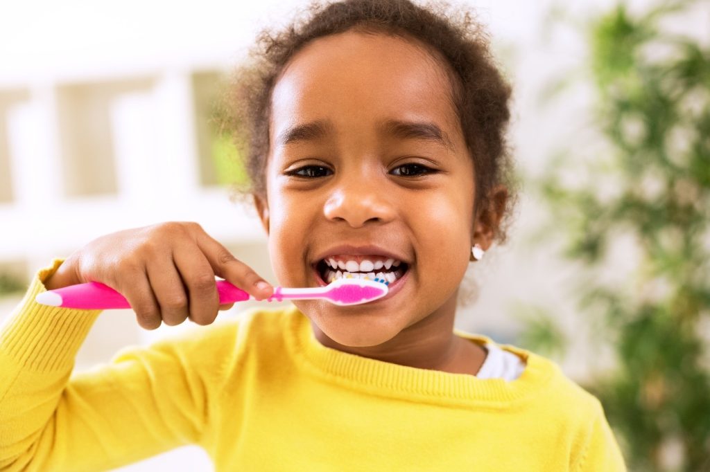 child brushing teeth