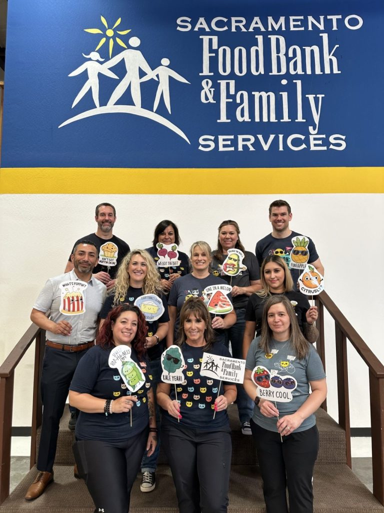 sacramento-food-bank Kids Care Dental & Orthodontic team smiling in front of the Sacramento Food Bank after a day of volunteering