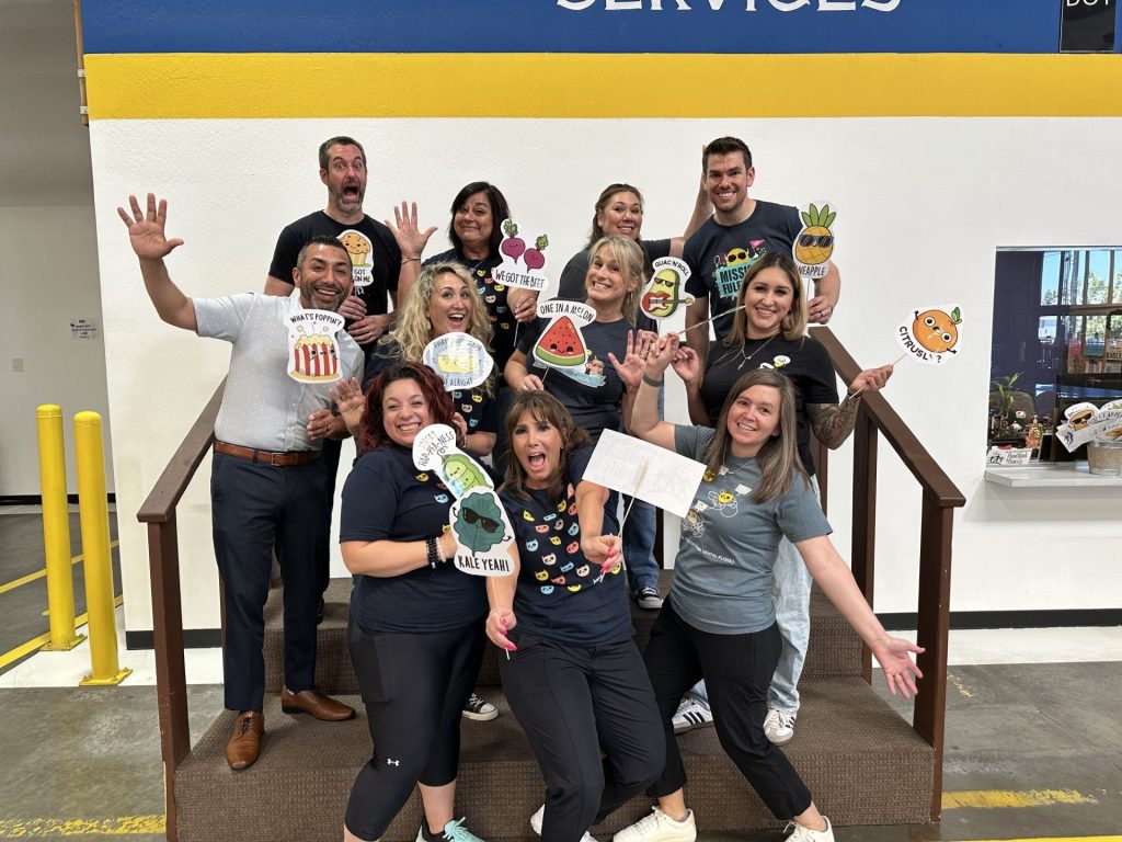 Kids Care Dental & Orthodontic team smiling in front of the Sacramento Food Bank after a day of volunteering