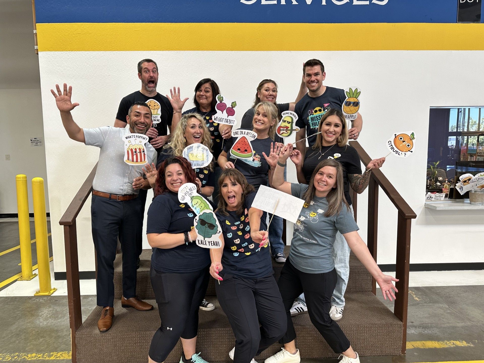 Kids Care Dental & Orthodontic team smiling in front of the Sacramento Food Bank after a day of volunteering