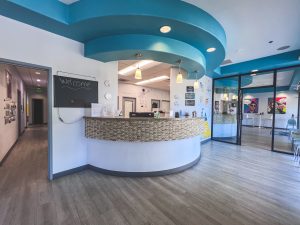 Pediatric dental and orthodontic office lobby with open reception space and welcoming atmosphere for children and parents